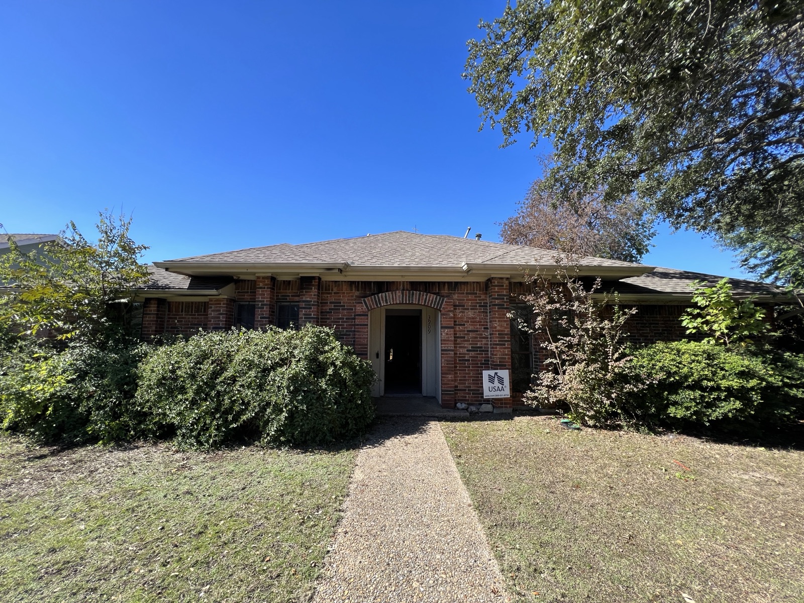 Fire-damaged front exterior of a Plano, TX home before restoration