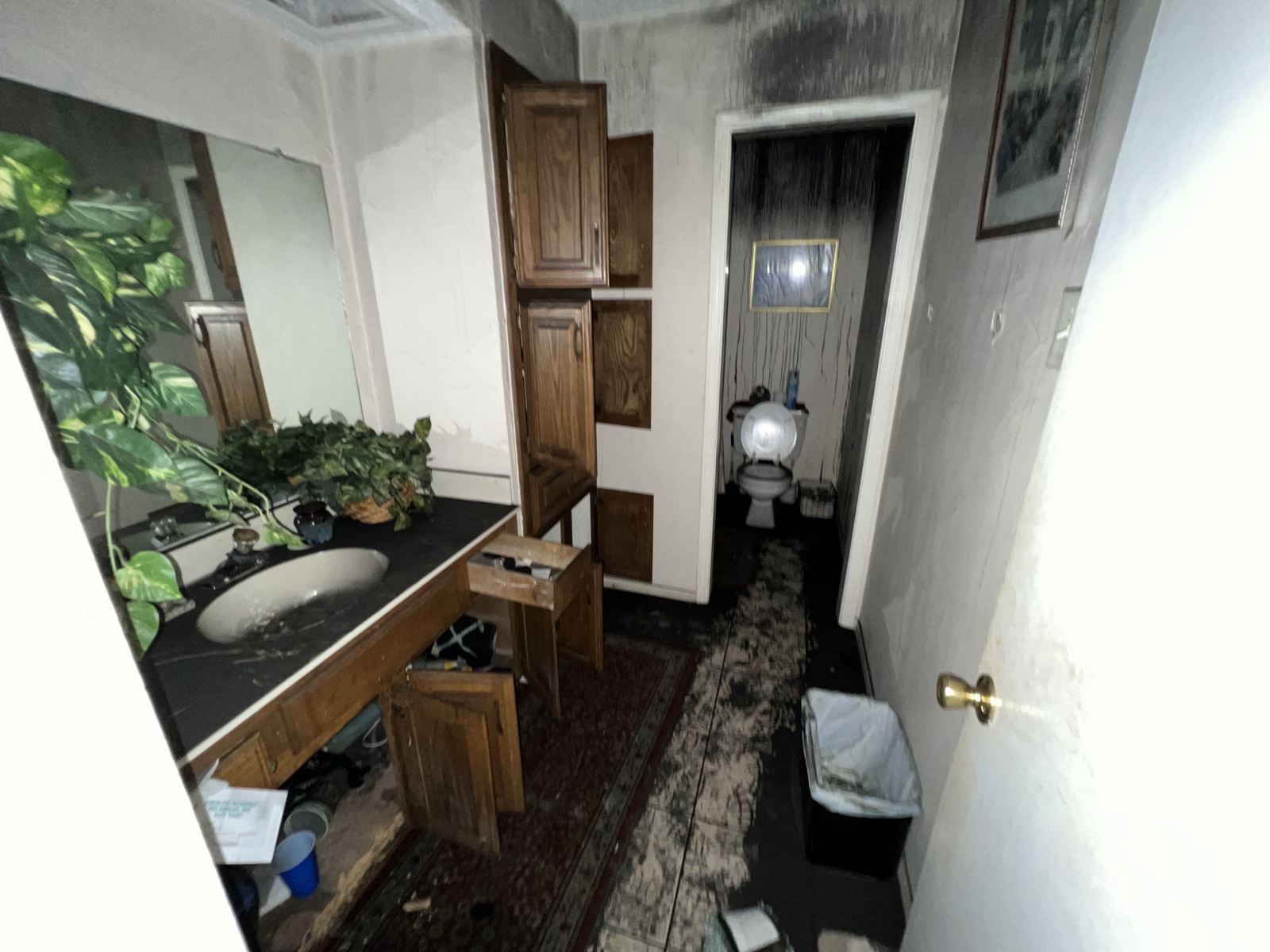 Fire damaged secondary bathroom in a Plano, TX home before restoration